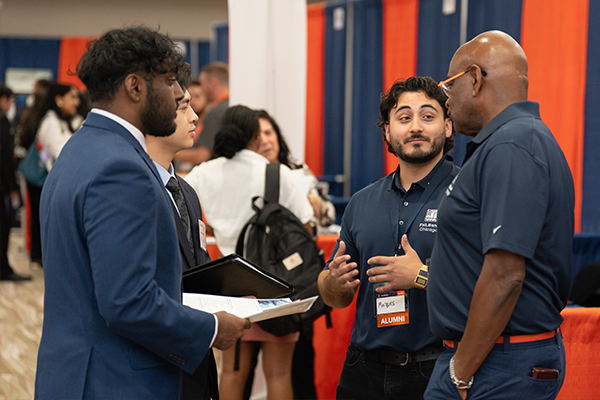 Students talking to employers at a career fair